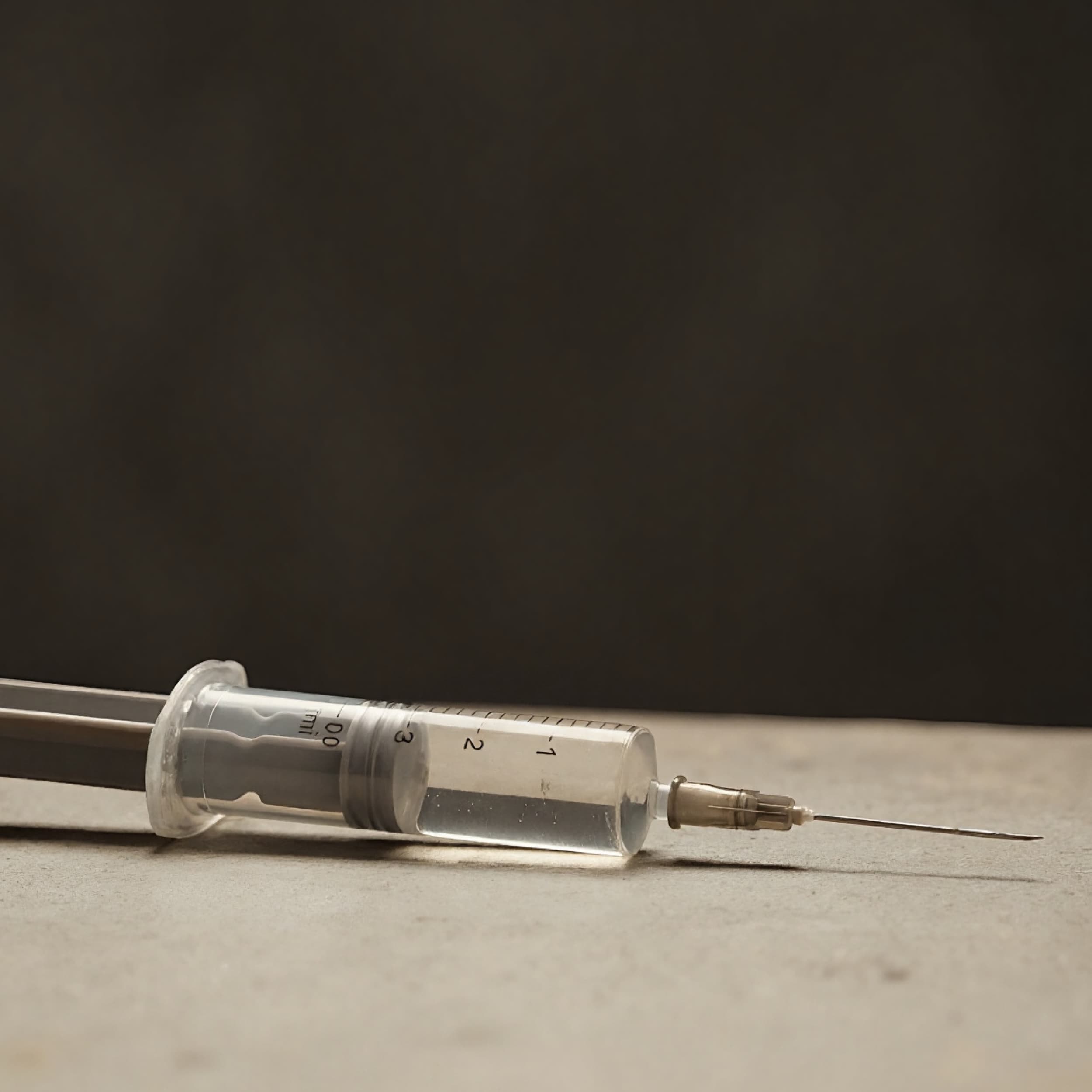 A syringe half-filled with clear liquid